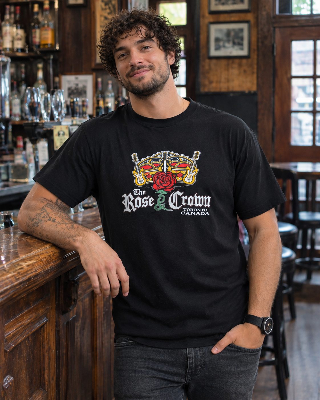 Model wearing the black Rose & Crown graphic T-shirt at the pub